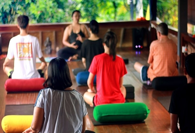 Wooden floor with people practicing yoga Yoga Studios Ubud Classes Practice Bali