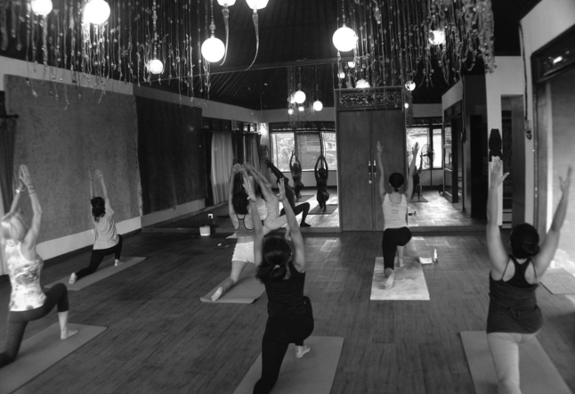 wooden floor with people practicing yoga Yoga Studios Ubud Classes Practice Bali