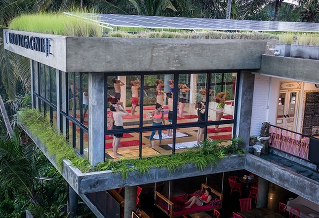 cement building with people practicing yoga indoor Yoga Studios Ubud Classes Practice Bali