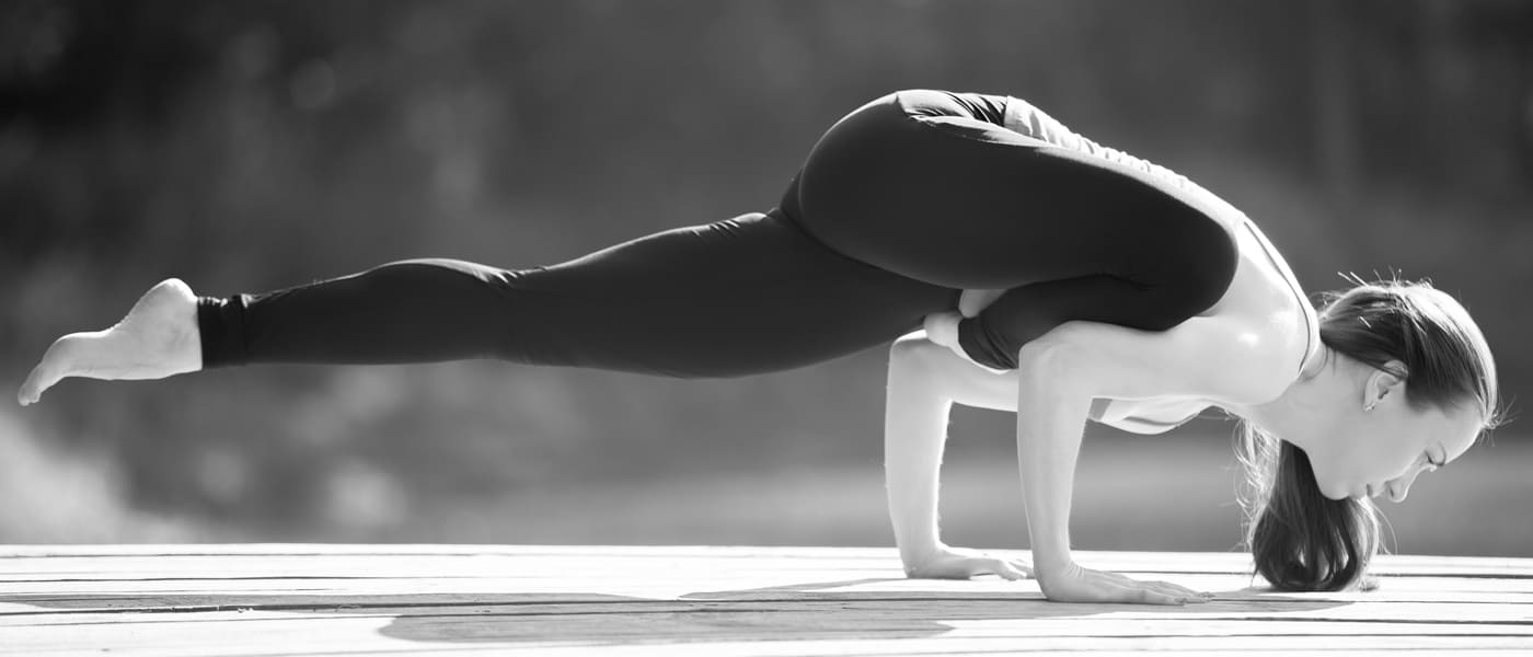 women in a yoga asana flying pigeon pose