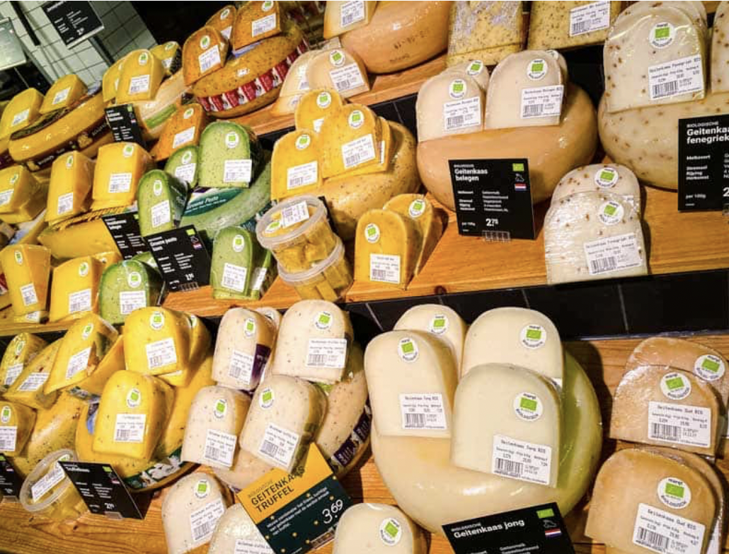A colourful display of organic cheeses at Marqt Amsterdam, illustrating the store’s emphasis on speciality food, quality ingredients and products selected for shoppers who value provenance and flavour.