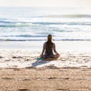 woman meditating in front of ocean 5 elemental meditation elements air water space earth fire vipassana buthas technique script