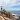 woman arms open on rock breathing facing ocean pranayama pranayam yoga breathing