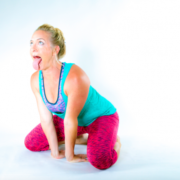 blonde woman red pants blue top lion pose simhasana