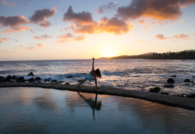 woman practicing yoga outdoor sunset spiritual meaning