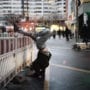 Person practicing yoga on a Berlin city street at dusk, blending urban movement with balance and stillness