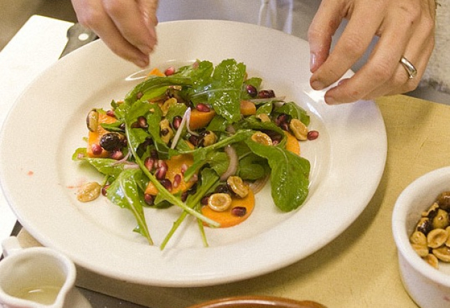 persimmon and pomegranate salad  with arugula and hazelnuts