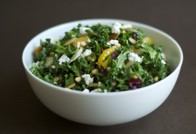 raw kale salad with feta, pine nuts, and cranberries