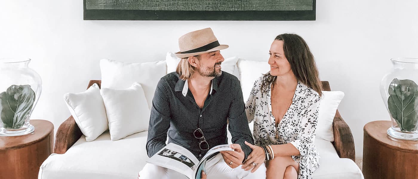 Founders of YOGI TIMES Sitting on a white couch