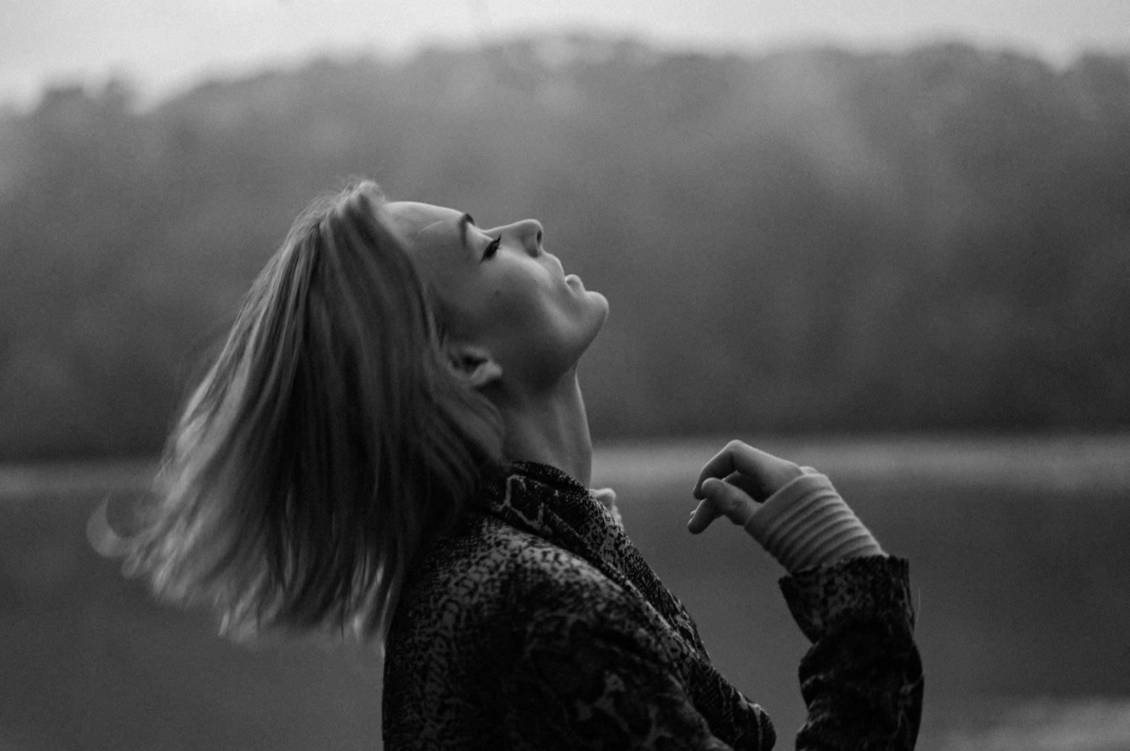 black and white photo of a woman with head back