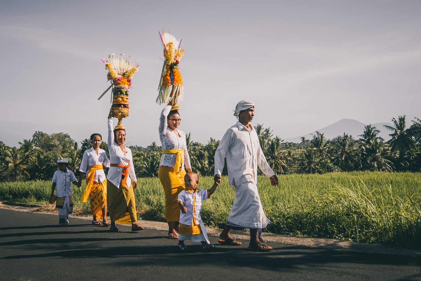 Balinese Family walking on Street Rice Fields Volcano Eco Wellness Retreat Ulaman Dino Magnatta Owner Bamboo