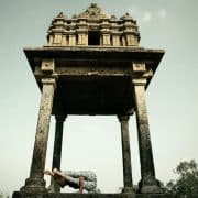 woman doing yoga in front of temple