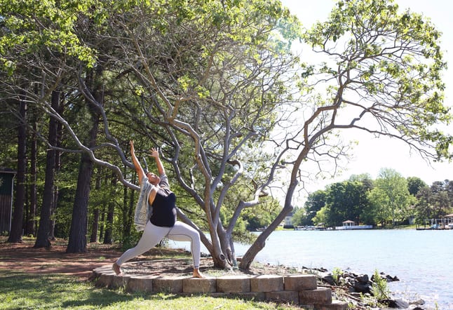 woman yoga pose outdoor by river hip replacement surgery practice healing