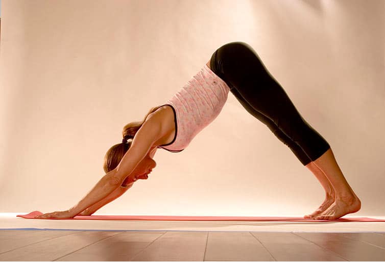 woman pose on mat yoga adho mukha svanasana (Downward-Facing Dog)