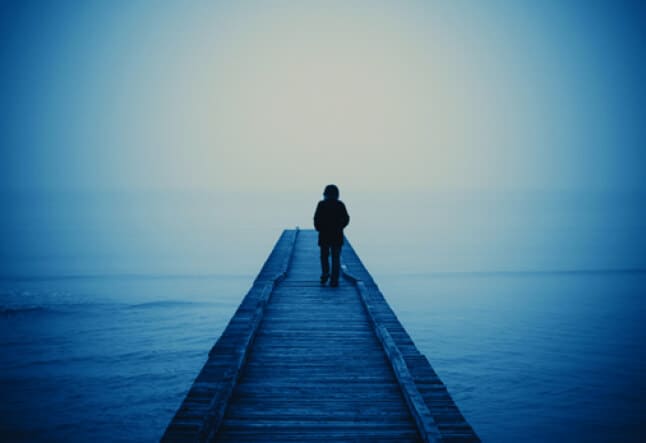 woman walking on a blue pier Recovery from Addiction with the Yoga Sutras