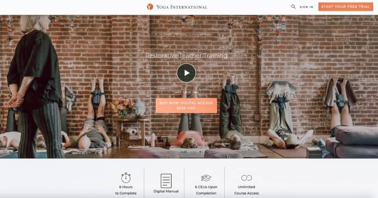 people laying down on wooden floor legs up on brick wall Yoga Certification Programs Online