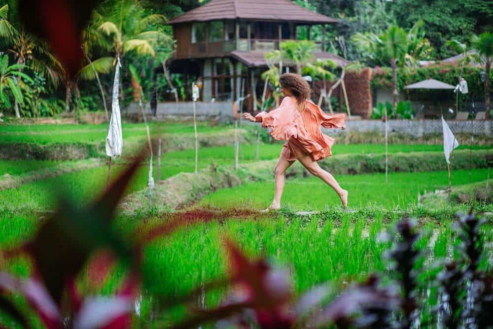 woman dancing in rice fields yoga retreat bali tantra women Ubud