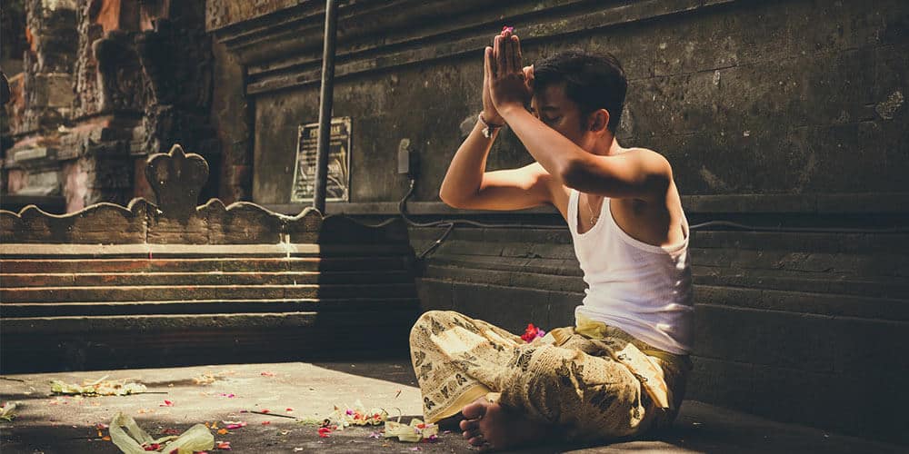 man praying at temple meaning of spiritual