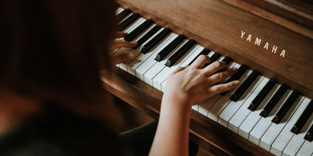 Woman playing the piano practising meditation in nature healing frequencies and Solfeggio Frequencies 417 hz 528 hz