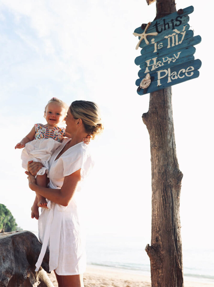 Joanna Hunt dressed in white in bali with her baby in armsFeminine energy motherhood maternity how to be more divine female side power