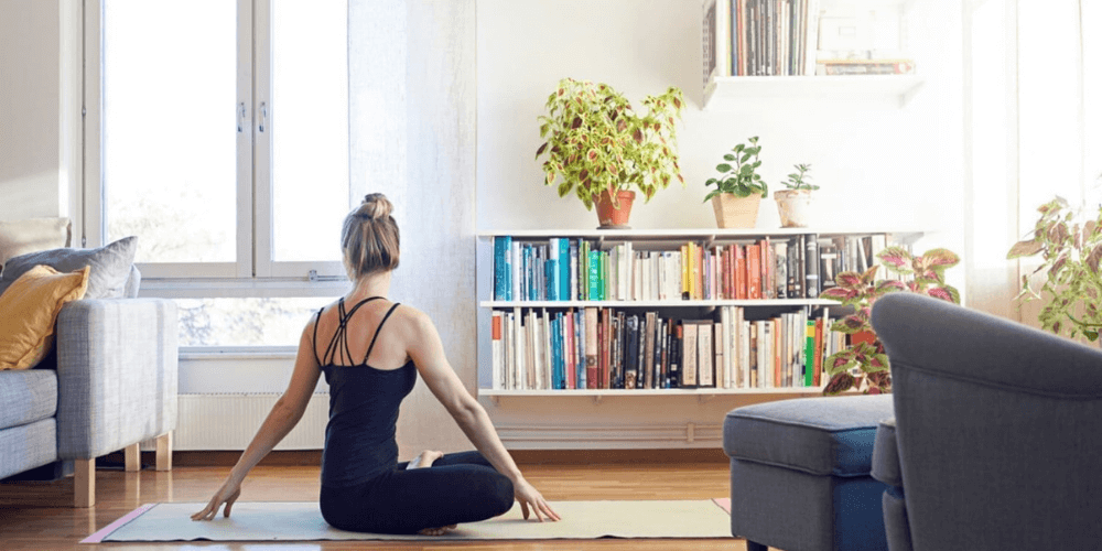 a woman practising yoga, Surya namaskar, sun salutation