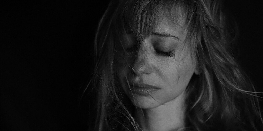 blonde woman crying during meditation, why do hip openers release emotionscrying posesrelease yogahip opening yoga