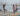 yoga group class by the beach Yoga instructor assisting studentsdoes yoga burn calories? how many calories does yoga burn yoga calories burned hot calculator