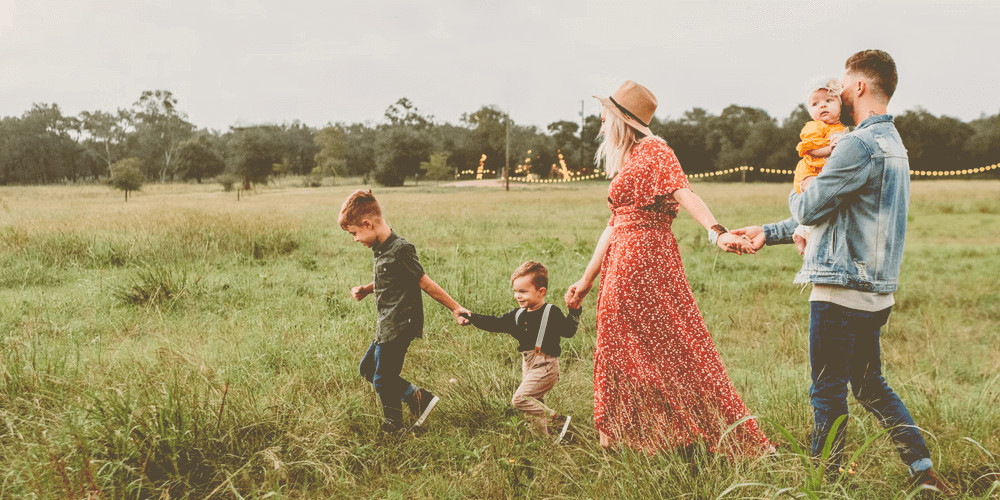 beautiful family walking in greenfield