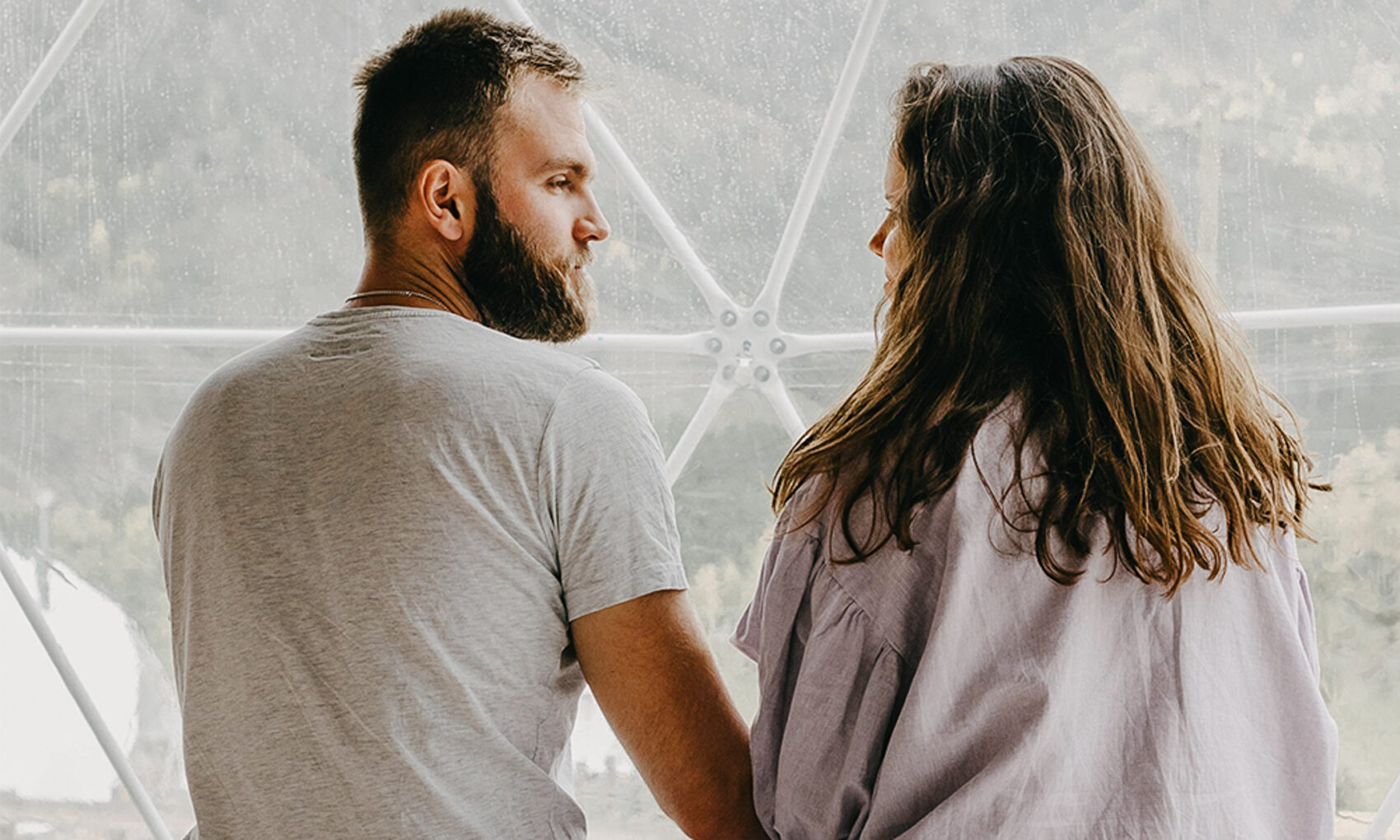 Man and woman sitting inside a geodome having a dialogue