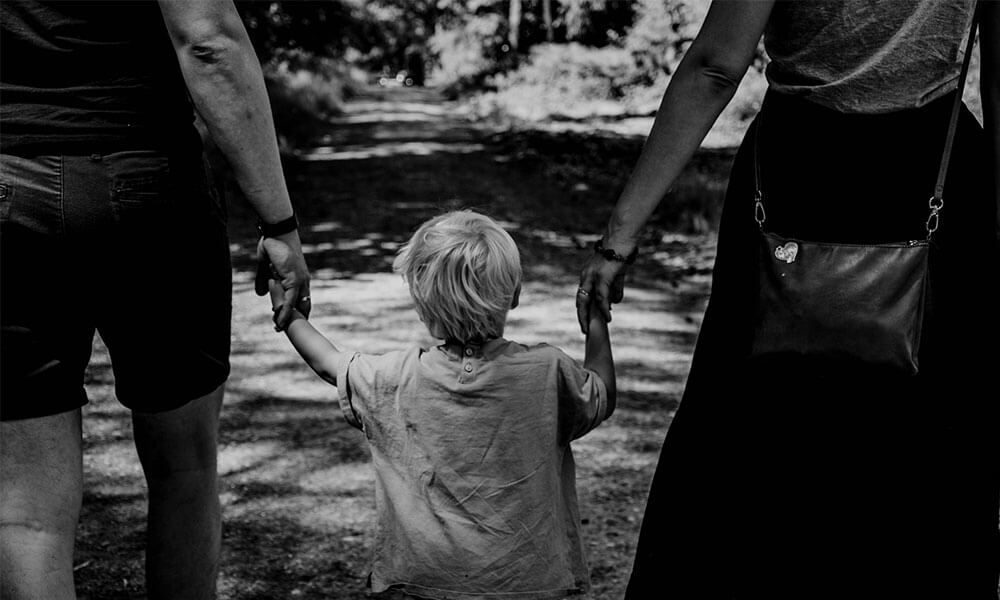 kid walking with parents