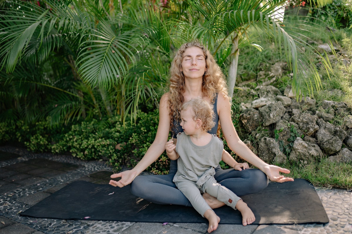 woman and kid on yoga mat