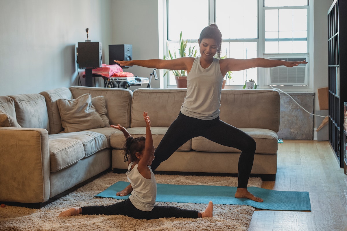 Woman and child doing yoga in warrior pose, divine feminine energy, meditation, yoga.