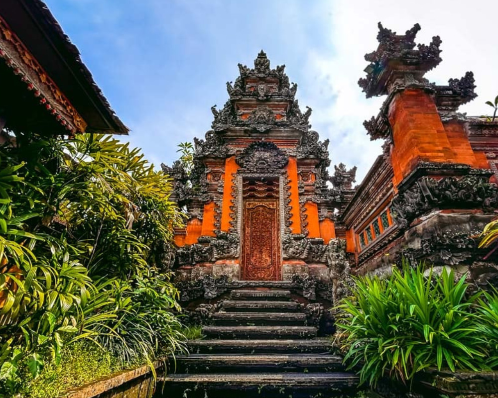 Traditional Balinese temple entrance with intricate carvings and vibrant colors