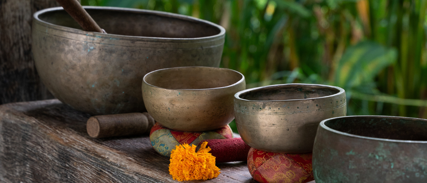 A calming yoga session in a pottery workshop, with pottery tools and clay on the workbench.