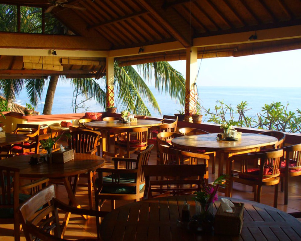 Outdoor retreat dining space with natural light and coastal scenery
