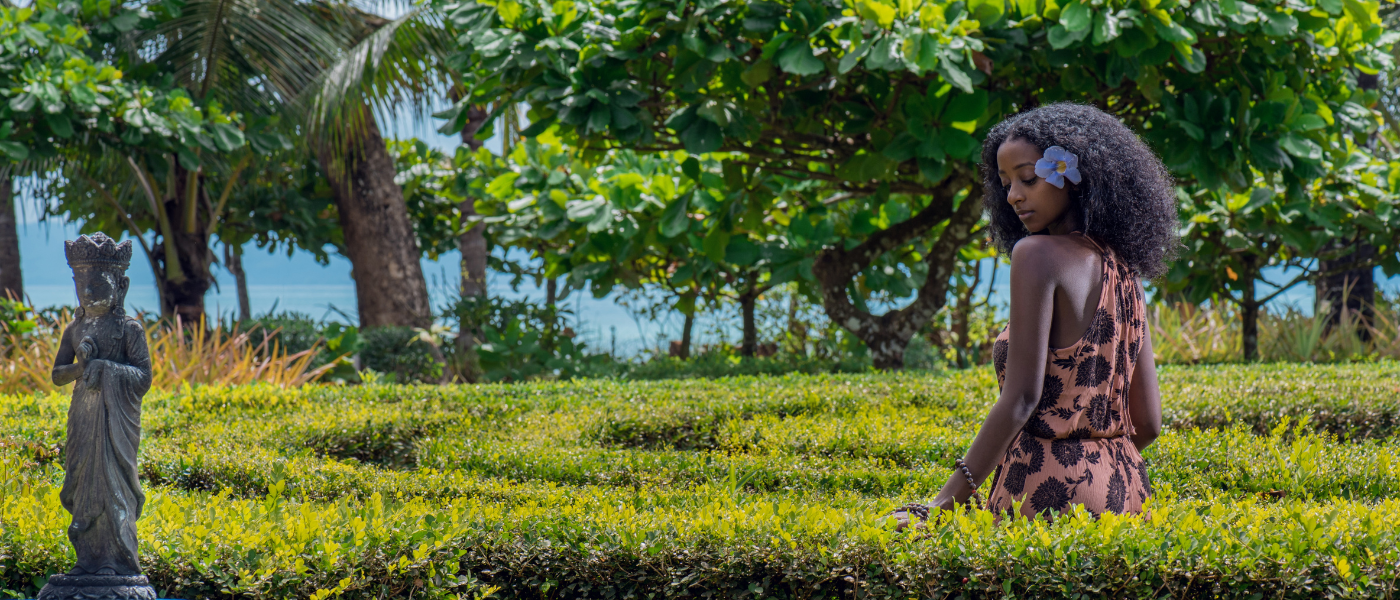 A woman in a lush garden, symbolizing Bali's natural beauty for a mind-body and spirit reset