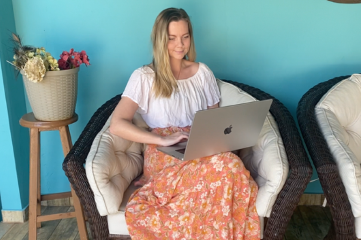 enille, Sacred Path Yoga student, completing her online 200-hour YTT on her laptop in a peaceful, cozy setting.