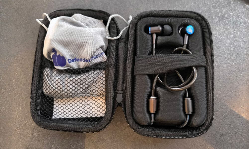 A set of EMF radiation free earbuds from DefenderShield displayed in the protective case.
