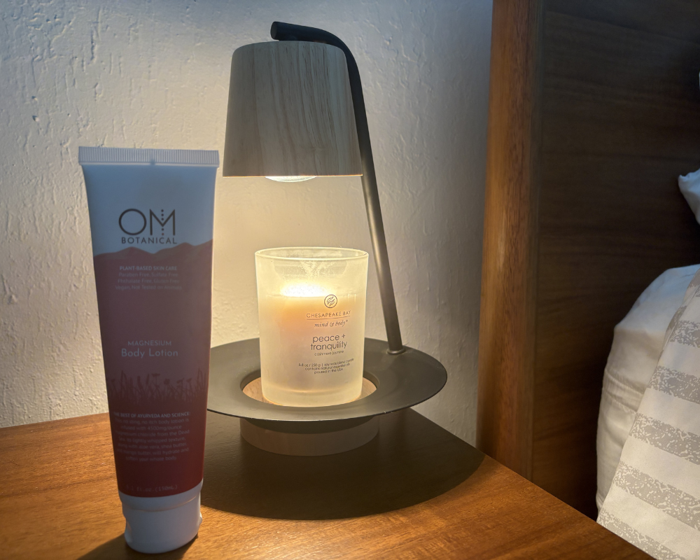 Applying OM Botanical magnesium body lotion to feet for relaxation and sleep support