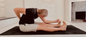 Man holding his lower back illustrating back pain after yoga and chronic lower back discomfort