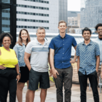 The OfferingTree team, including co-founders Chris Appiah, Alex Haley, and Tom McCook, standing together at the company's headquarters.