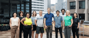 The OfferingTree team, including co-founders Chris Appiah, Alex Haley, and Tom McCook, standing together at the company's headquarters.