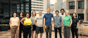 The OfferingTree team, including co-founders Chris Appiah, Alex Haley, and Tom McCook, standing together at the company's headquarters.