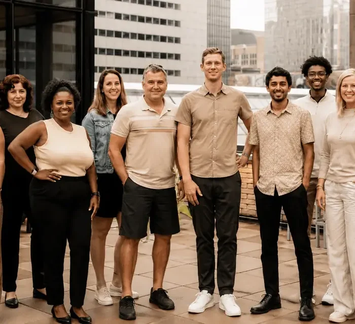 The OfferingTree team, including co-founders Chris Appiah, Alex Haley, and Tom McCook, standing together at the company's headquarters.