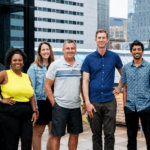 The OfferingTree team, including co-founders Chris Appiah, Alex Haley, and Tom McCook, standing together at the company's headquarters.