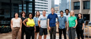 The OfferingTree team, including co-founders Chris Appiah, Alex Haley, and Tom McCook, standing together at the company's headquarters.