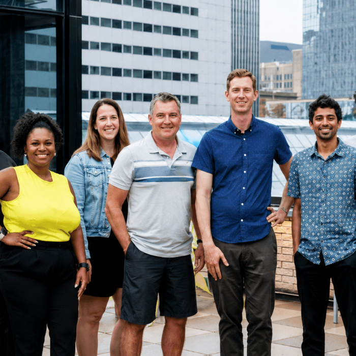 The OfferingTree team, including co-founders Chris Appiah, Alex Haley, and Tom McCook, standing together at the company's headquarters.