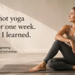 Woman sitting on a yoga mat after completing a seven-day hot yoga challenge in a calm yoga studio.